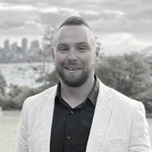 Toolbox Team: A black and white photo of Matthew soles with the Sydney harbour in the background